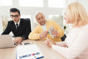 Older people with money and their attorney preparing a power of attorney